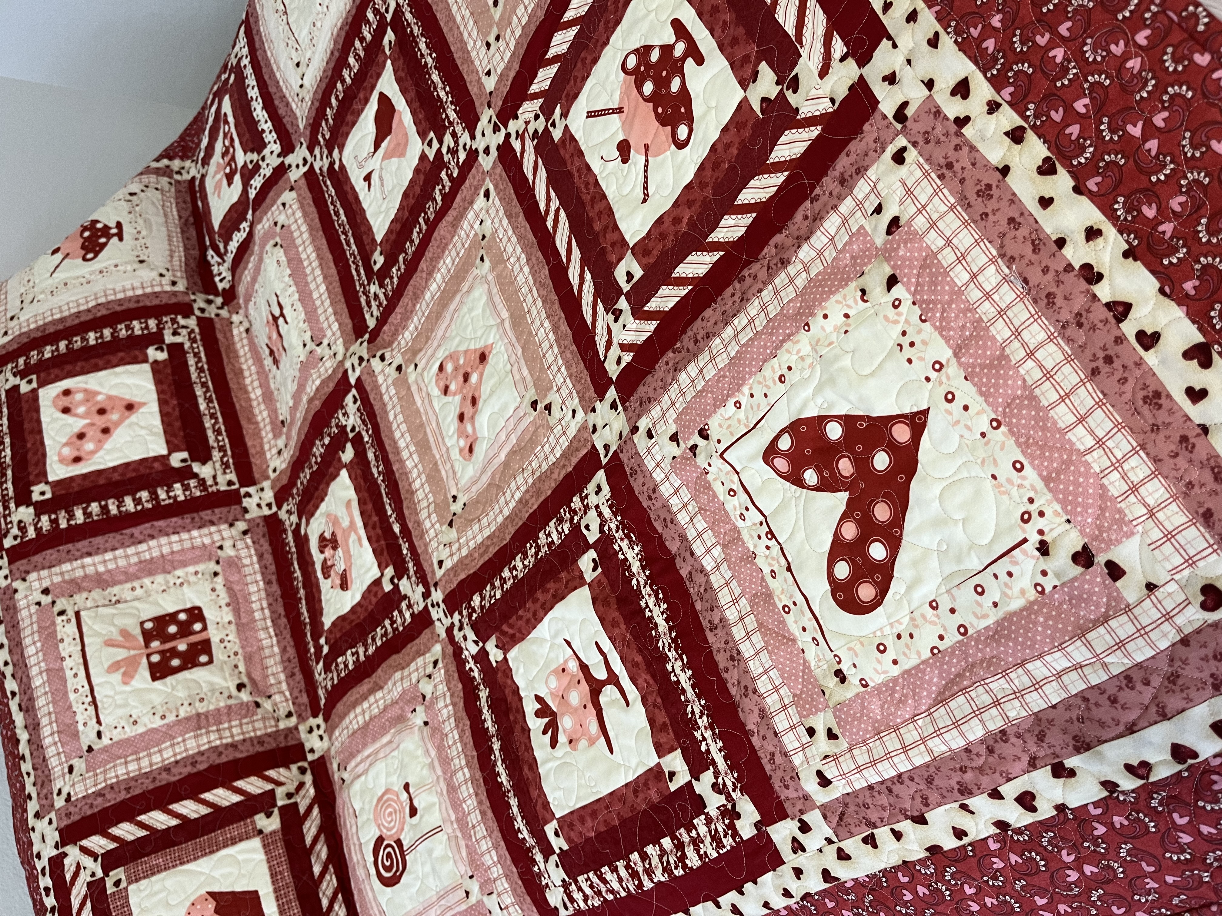 Hearts pattern quilt on bed