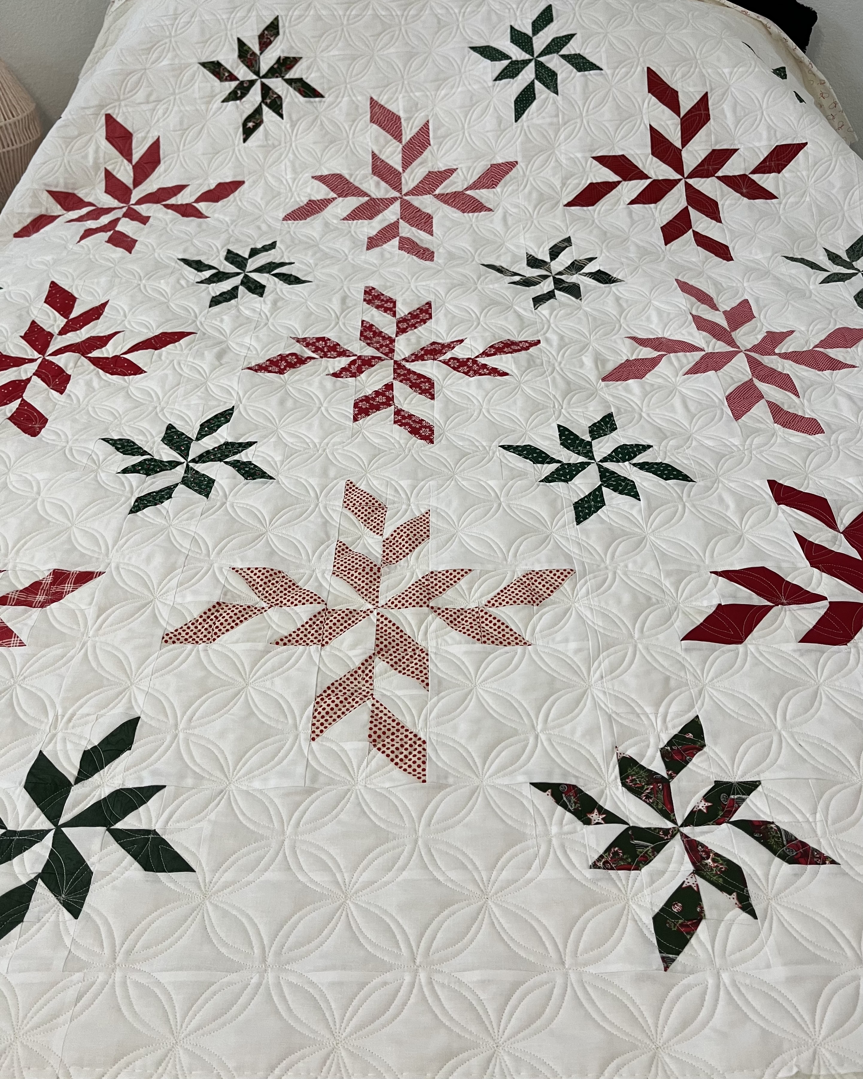Spiral pattern quilt on bed