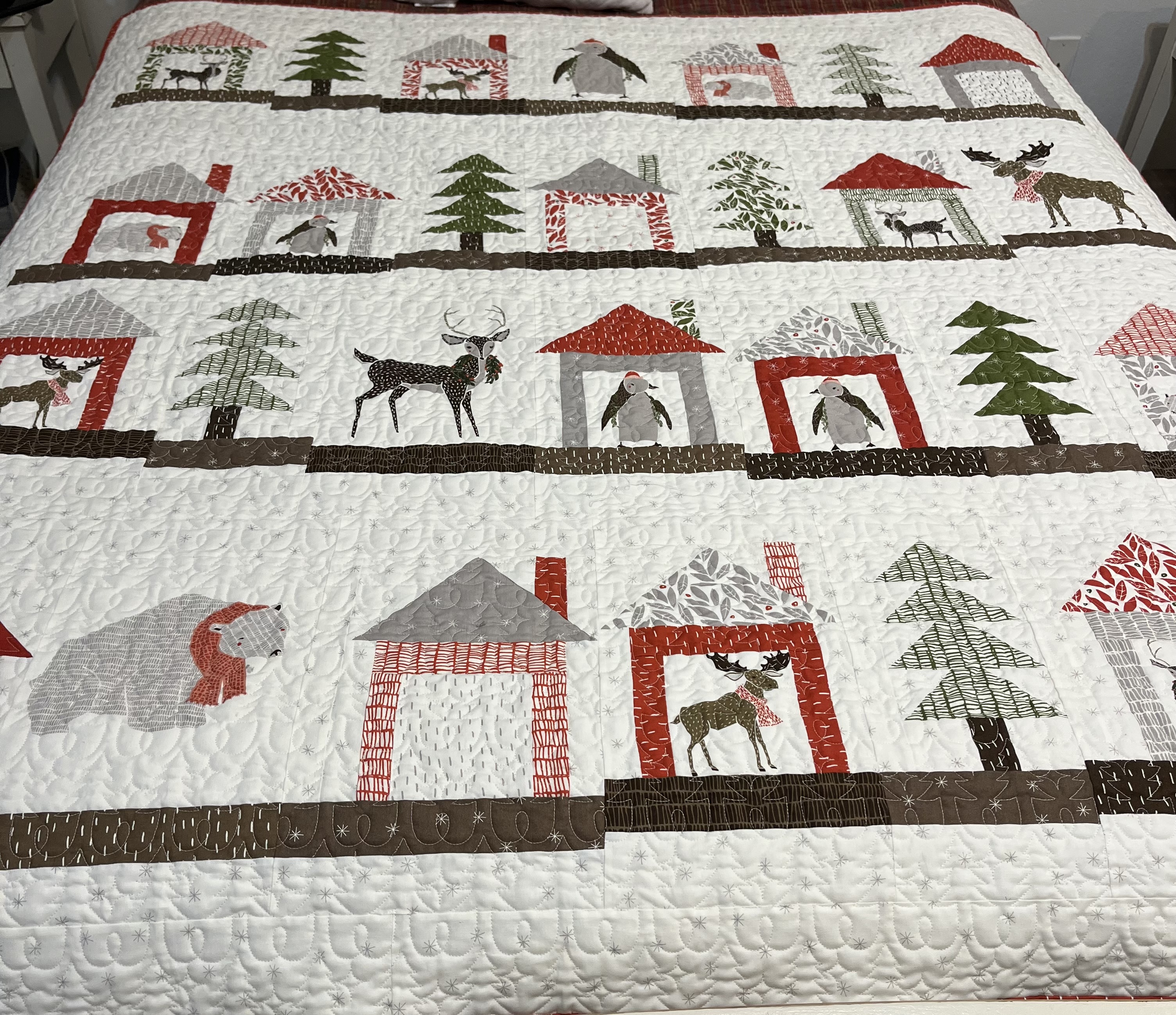 Winter themed quilt on bed